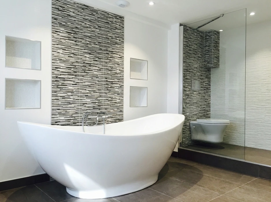 Salle de bain contemporaine avec baignoire îlot autoportante blanche en acrylique, robinetterie chromée encastrée